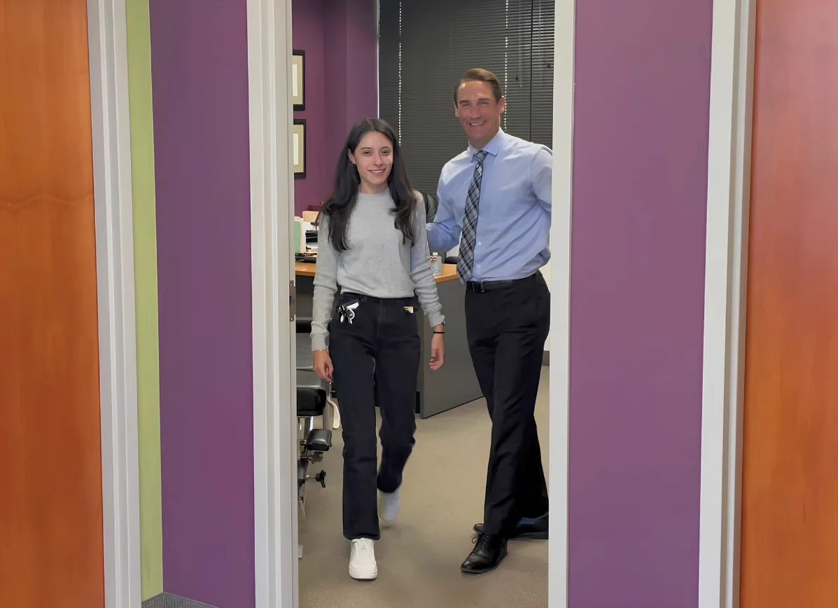 Tatiana welcoming a patient during a relaxed, efficient first visit at Plymouth Spine and Health Center